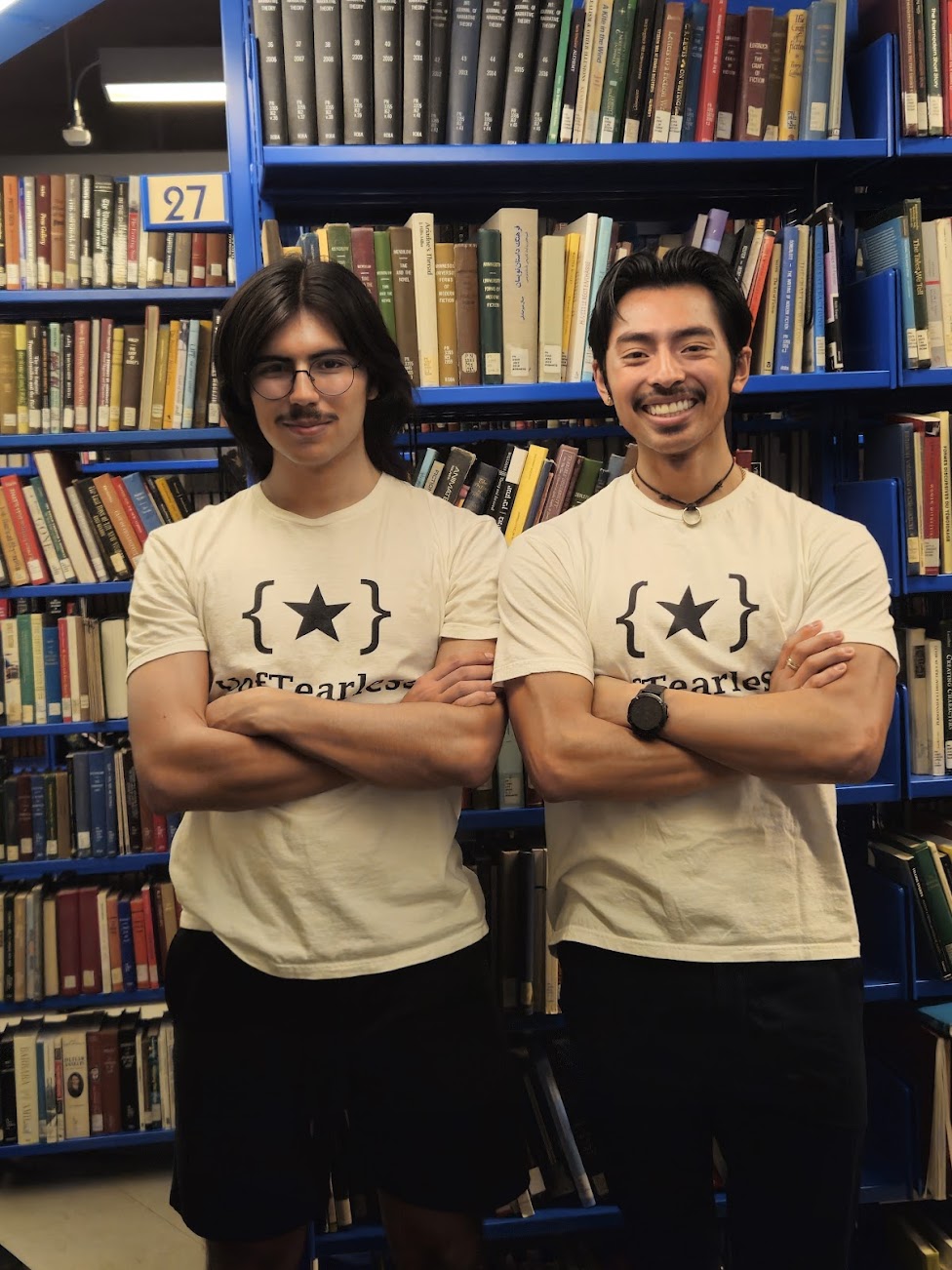 Me and Simon wearing UofTearless-branded t-shirts inside the University of Toronto's Robarts Library.
